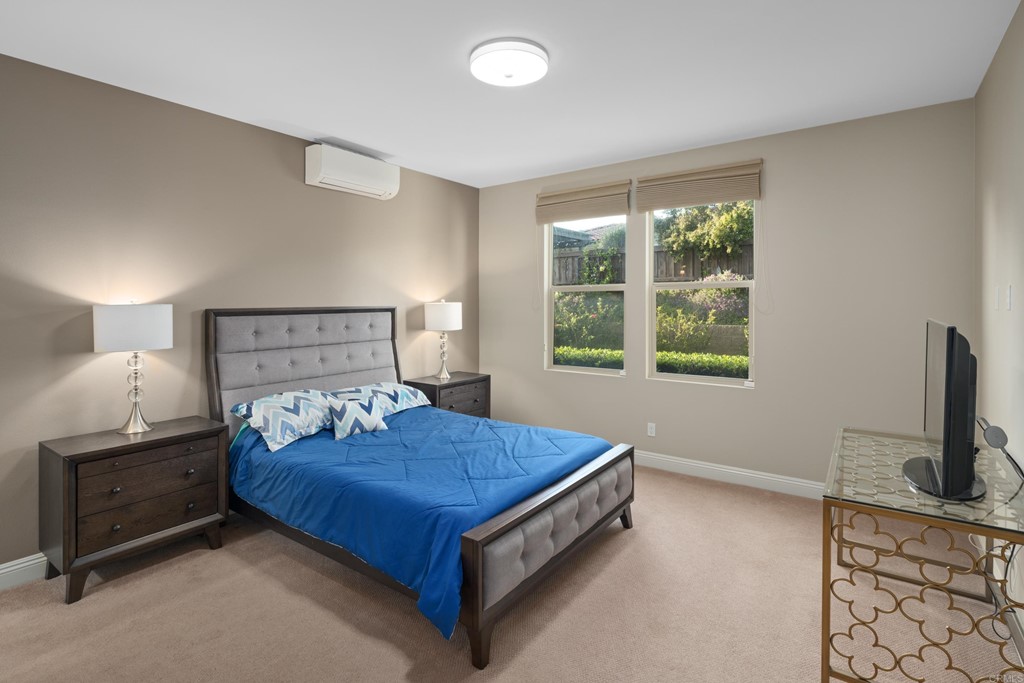 698 Normandy Road Encinitas, CA 92024 - Photo 17 of 35 a bedroom with a bed and a flat tv screen on a dresser