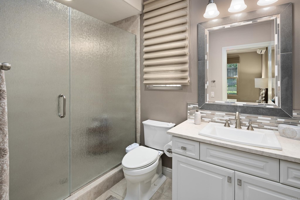 698 Normandy Road Encinitas, CA 92024 - Photo 18 of 35 a bathroom with a sink toilet and shower