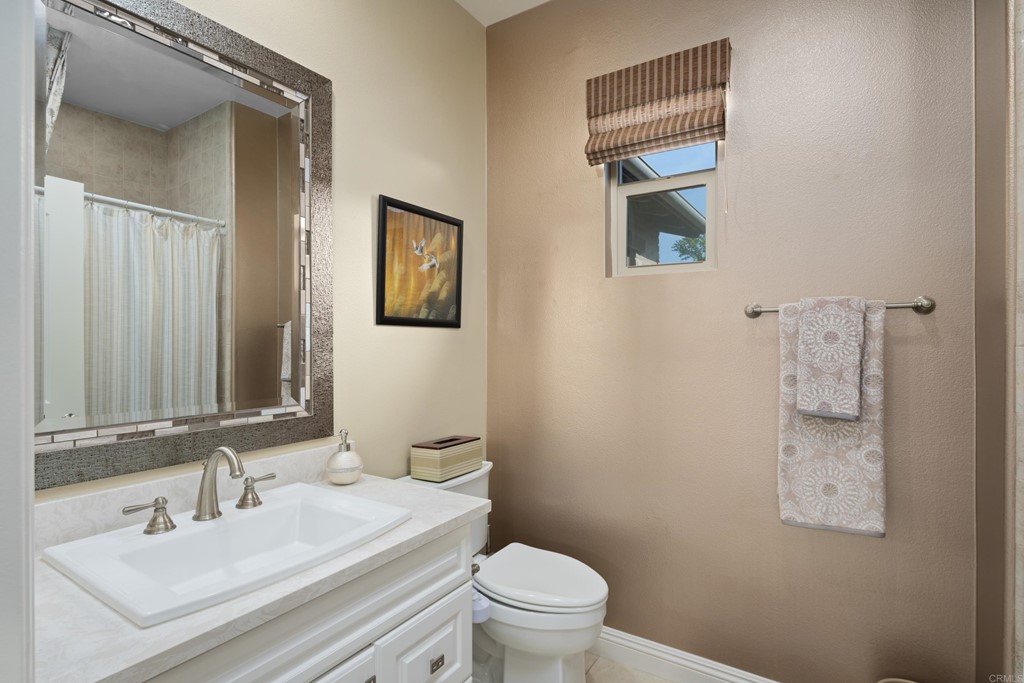 698 Normandy Road Encinitas, CA 92024 - Photo 22 of 35 a bathroom with a toilet sink and mirror