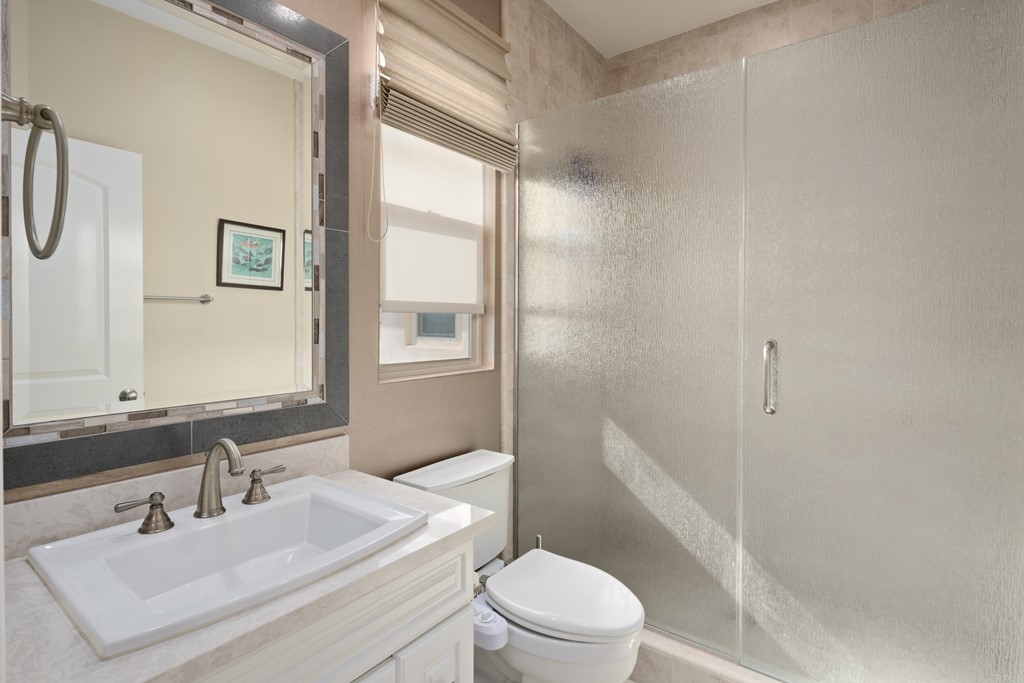 698 Normandy Road Encinitas, CA 92024 - Photo 30 of 35 a bathroom with a sink toilet and shower