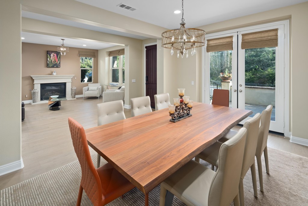 698 Normandy Road Encinitas, CA 92024 - Photo 4 of 35 a dining room with furniture a chandelier and window