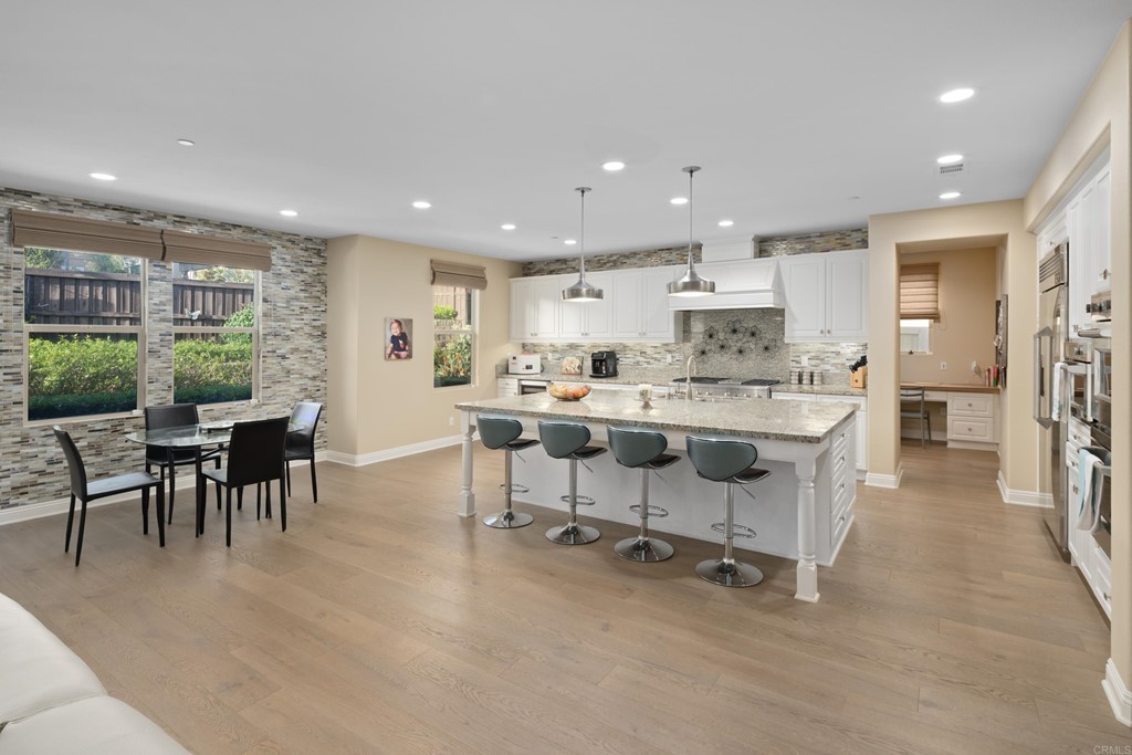 698 Normandy Road Encinitas, CA 92024 - Photo 9 of 35 a living room with stainless steel appliances kitchen island granite countertop furniture and a dining table