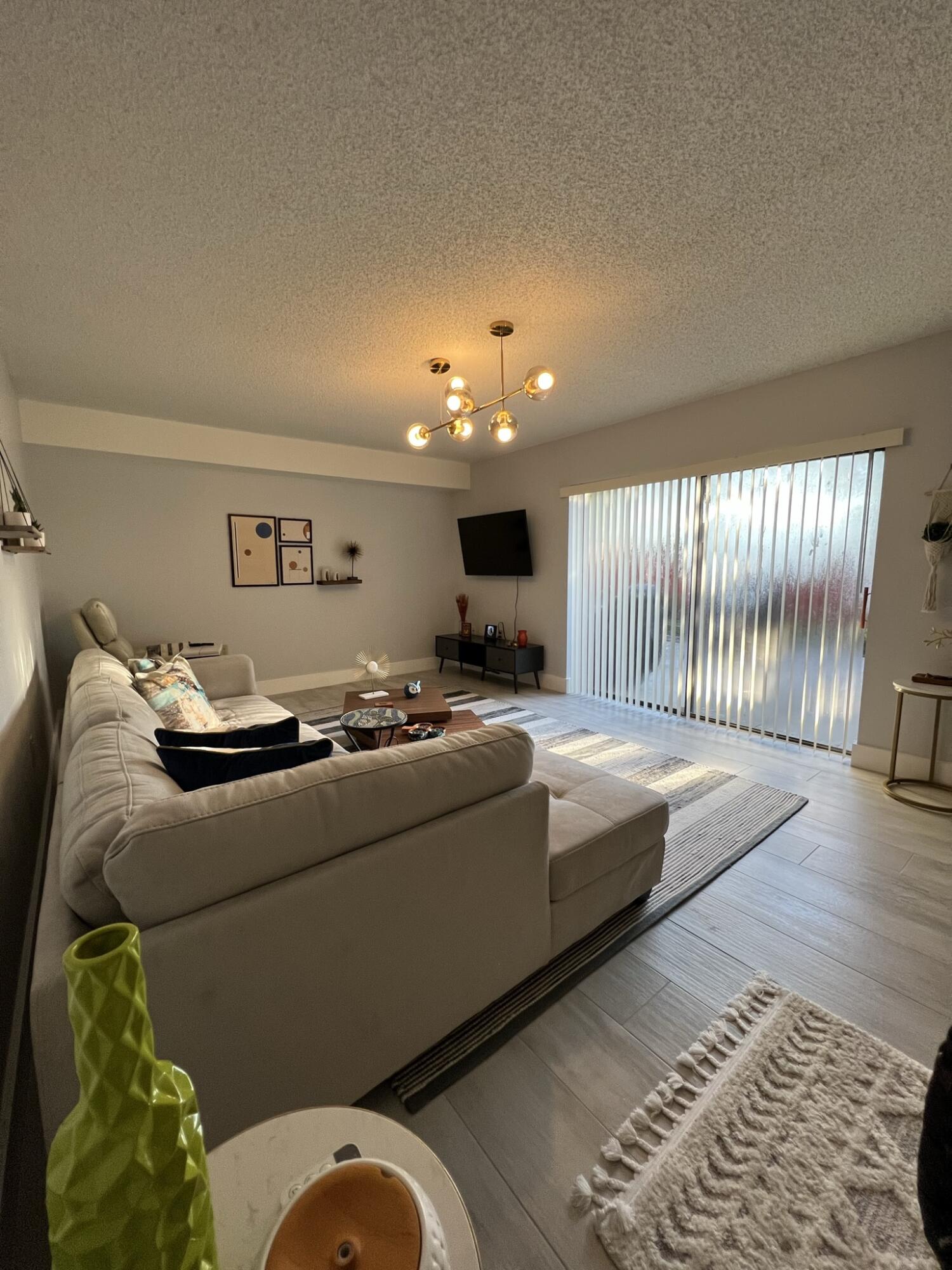 802 Blue Ridge Circle West Palm Beach, FL 33409 - Photo 11 of 37 a living room with furniture and a flat screen tv