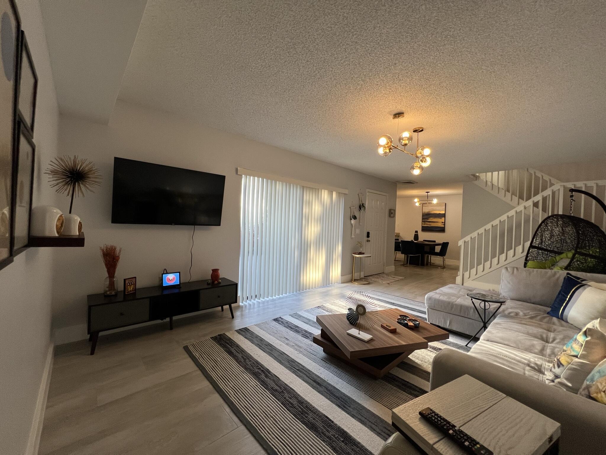 802 Blue Ridge Circle West Palm Beach, FL 33409 - Photo 12 of 37 a living room with furniture and a flat screen tv