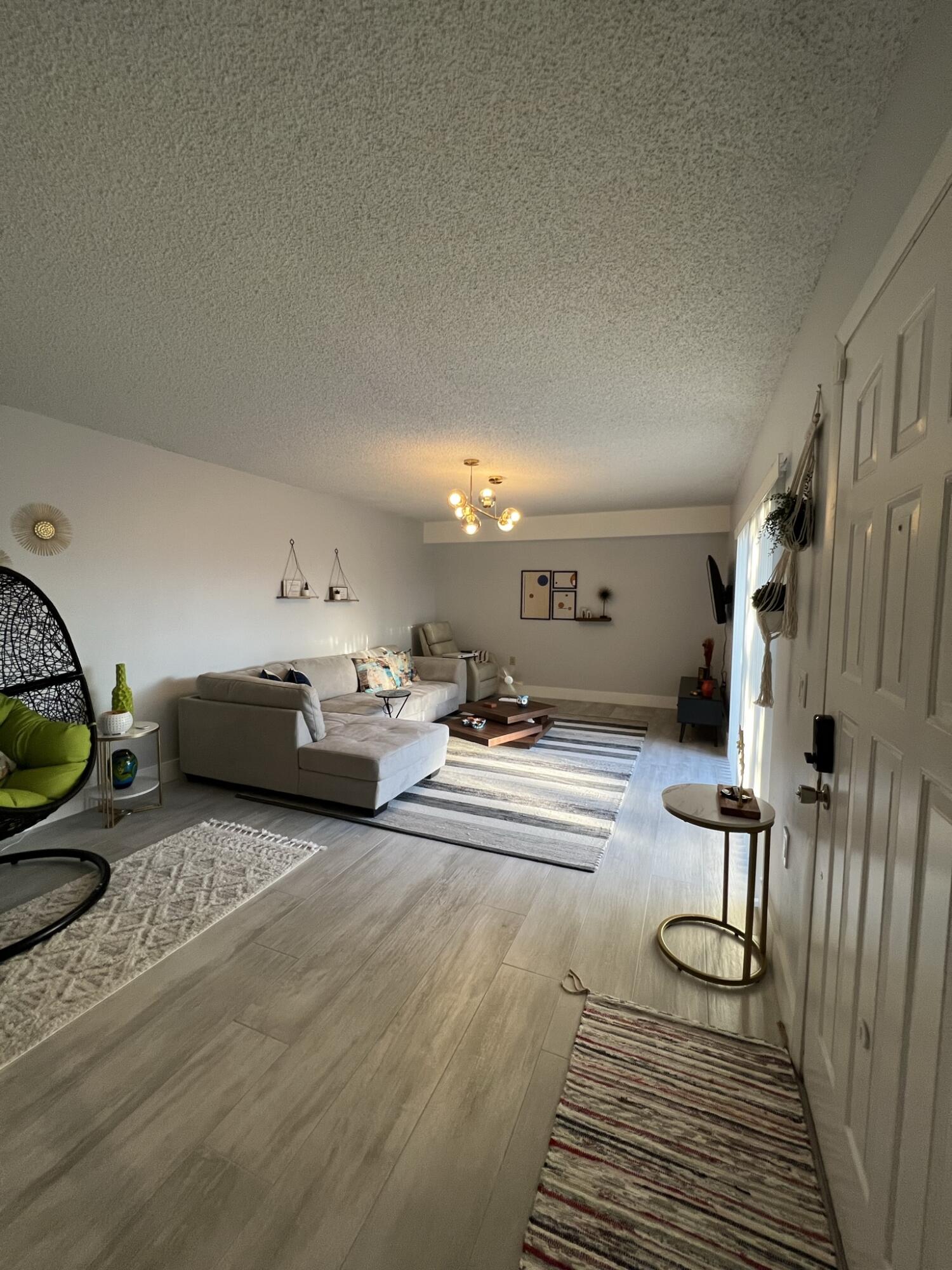 802 Blue Ridge Circle West Palm Beach, FL 33409 - Photo 13 of 37 a living room with furniture a rug and a fireplace