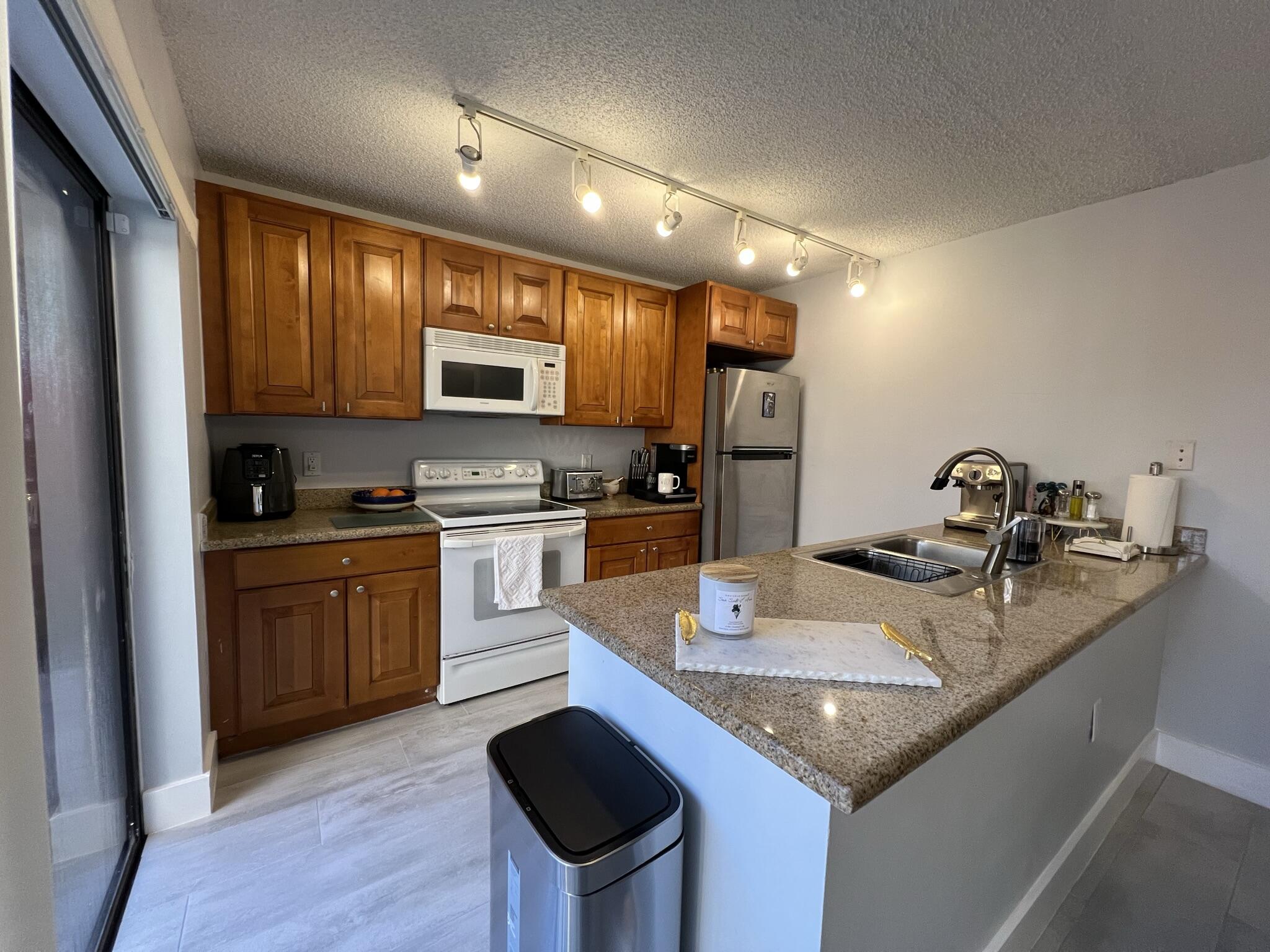 802 Blue Ridge Circle West Palm Beach, FL 33409 - Photo 15 of 37 a kitchen with a sink stove and refrigerator