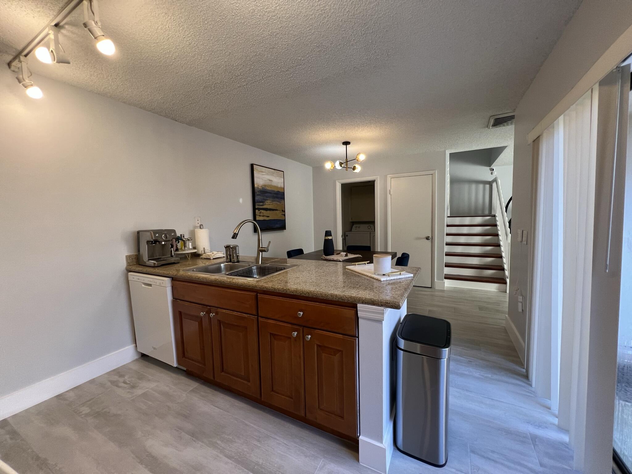 802 Blue Ridge Circle West Palm Beach, FL 33409 - Photo 16 of 37 a kitchen with cabinets and chairs