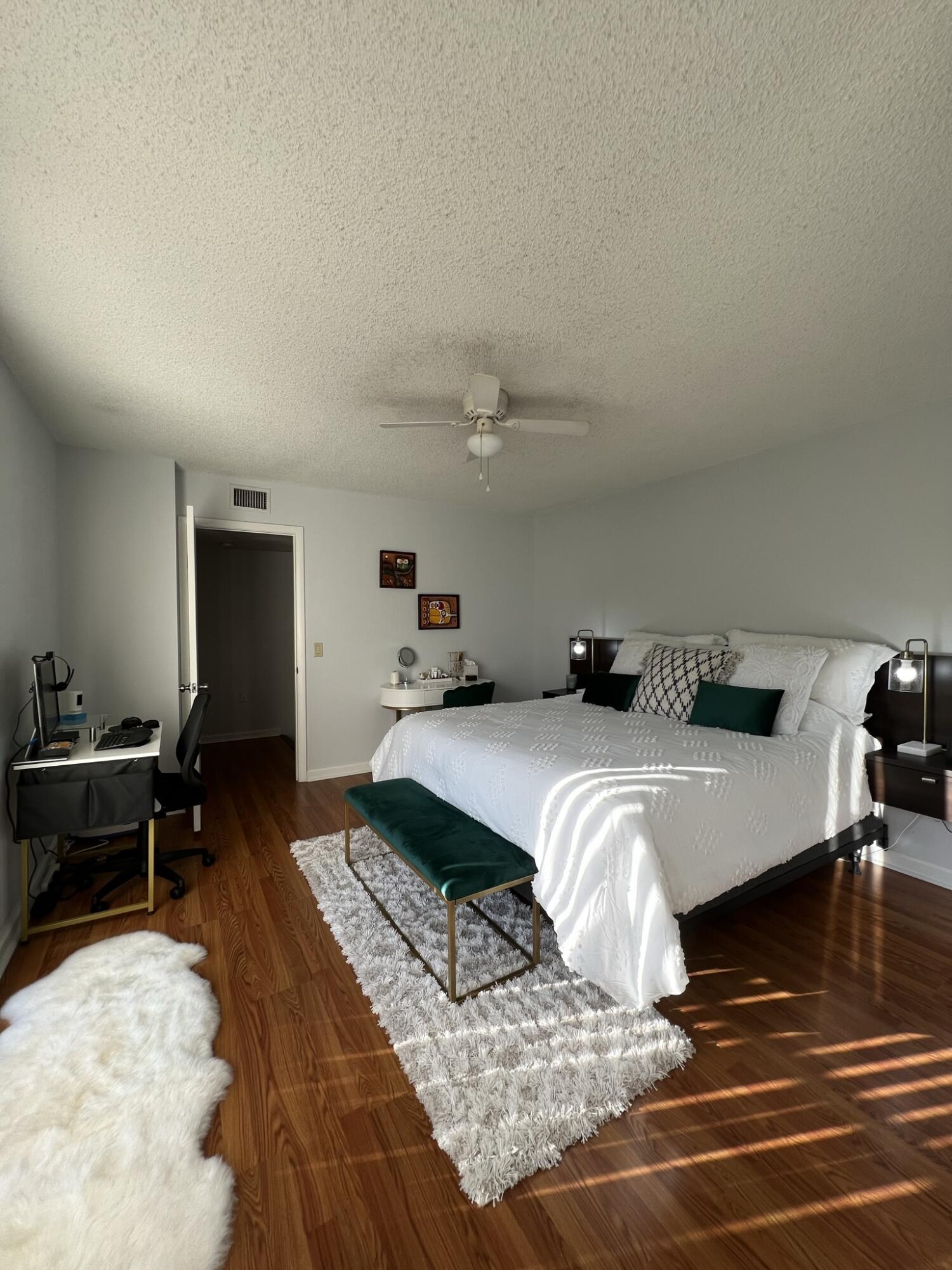 802 Blue Ridge Circle West Palm Beach, FL 33409 - Photo 21 of 37 a bedroom with a bed and wooden floor