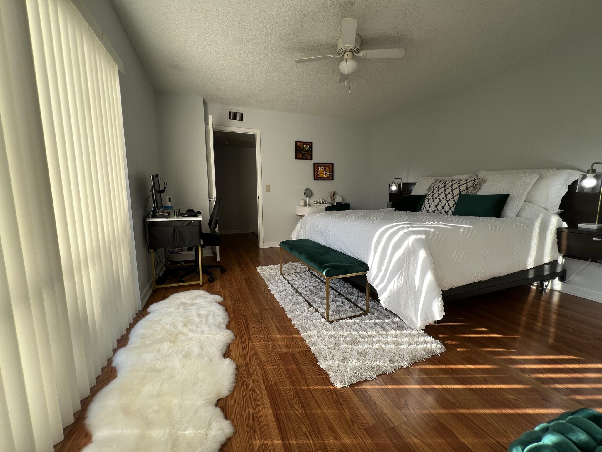 802 Blue Ridge Circle West Palm Beach, FL 33409 - Photo 22 of 37 a bedroom with a bed and wooden floor