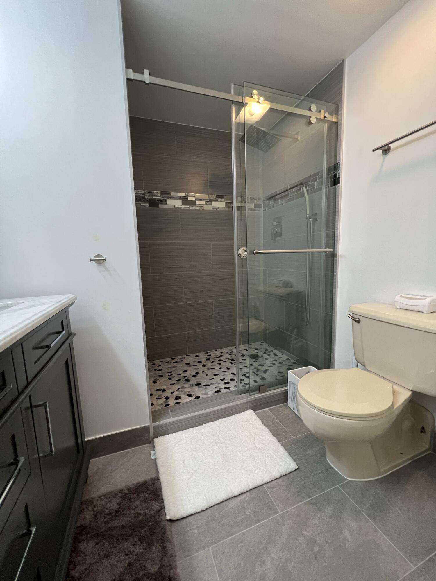 802 Blue Ridge Circle West Palm Beach, FL 33409 - Photo 27 of 37 a bathroom with a toilet and a shower