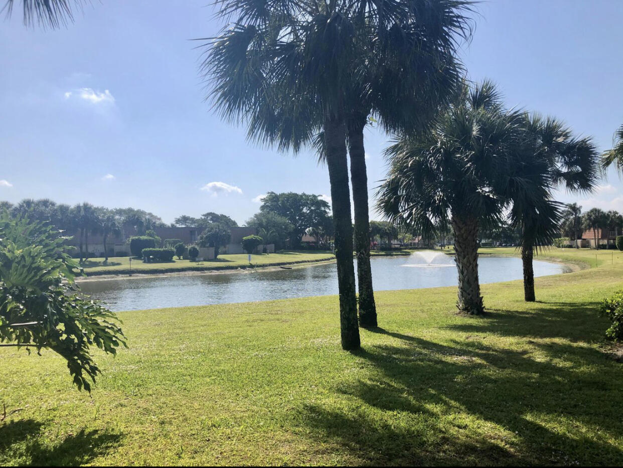 802 Blue Ridge Circle West Palm Beach, FL 33409 - Photo 3 of 37 a view of a lake with a yard