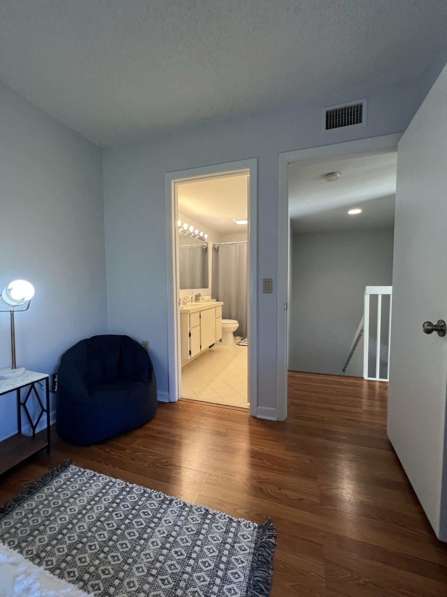 802 Blue Ridge Circle West Palm Beach, FL 33409 - Photo 35 of 37 a bedroom with wooden floor and a bathroom