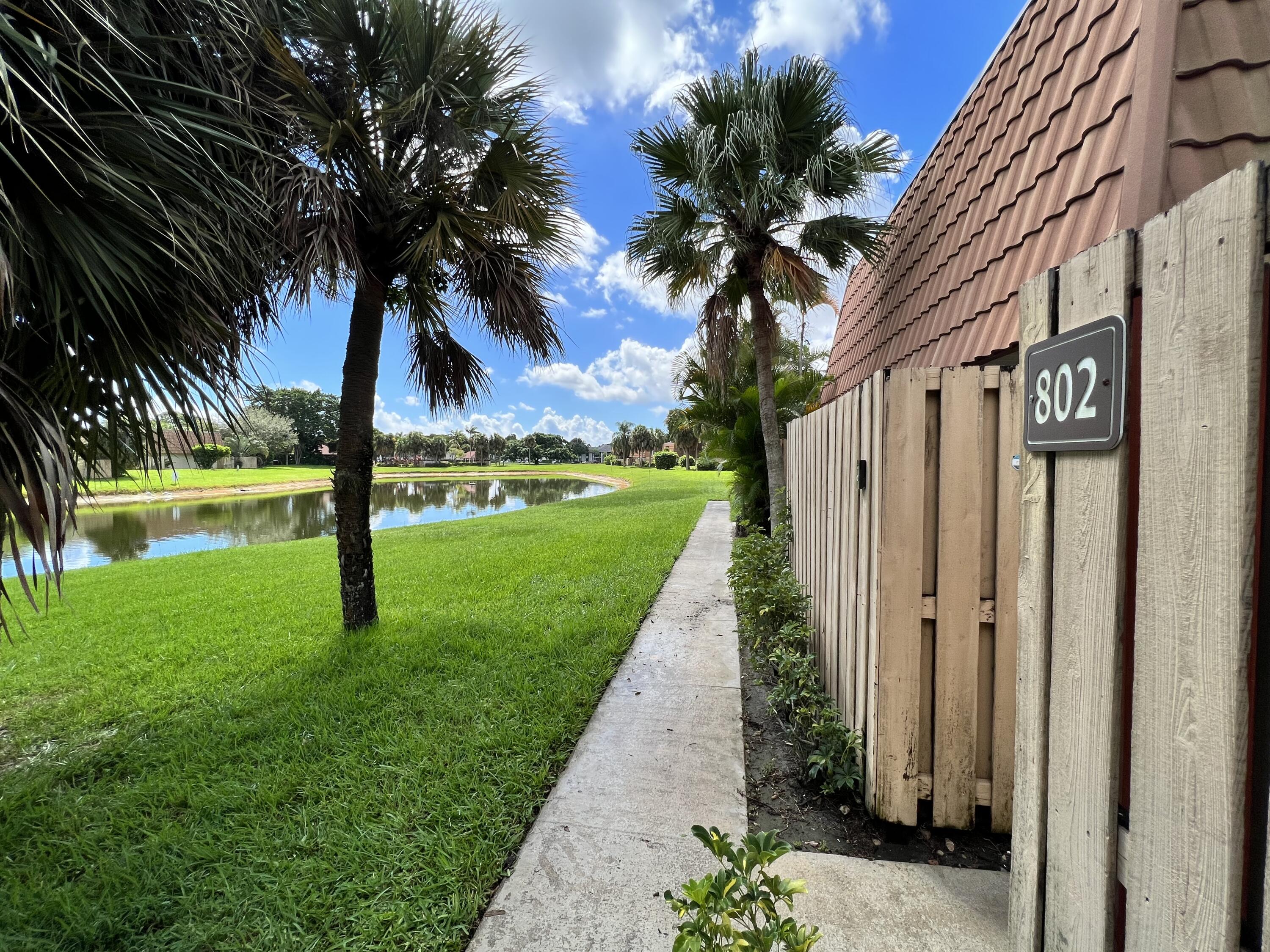 802 Blue Ridge Circle West Palm Beach, FL 33409 - Photo 4 of 37 a view of a yard with a palm tree