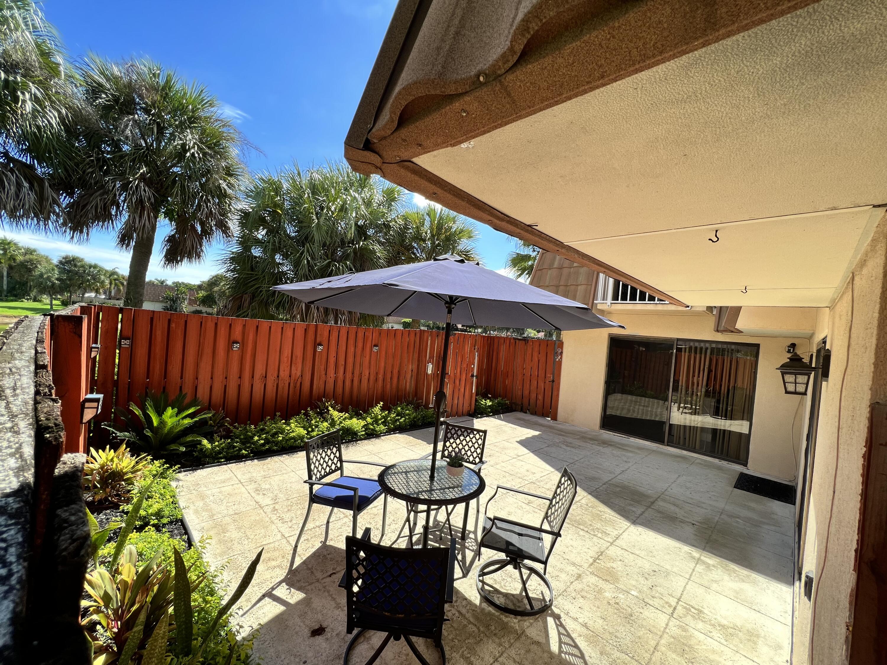 802 Blue Ridge Circle West Palm Beach, FL 33409 - Photo 6 of 37 a view of an chairs and table in the patio