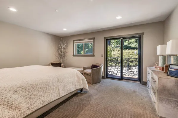 a spacious bedroom with a large bed and a large window
