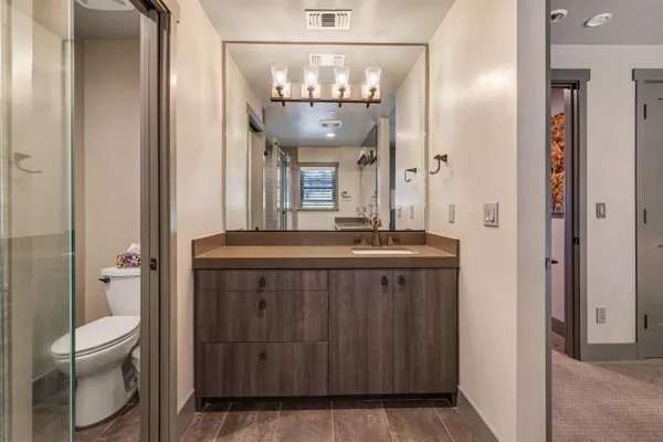 a bathroom with a sink vanity and a mirror