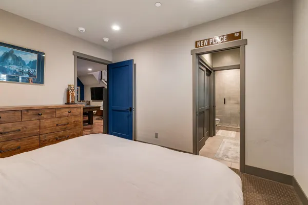 a bathroom with a granite countertop sink a mirror and a bathtub