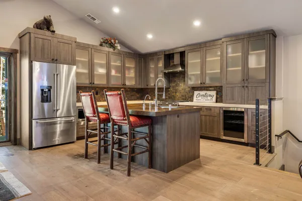 a kitchen with kitchen island a sink stove and refrigerator