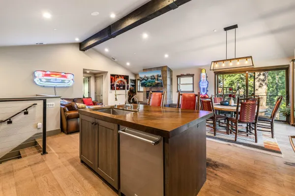 a kitchen with stainless steel appliances granite countertop sink stove and wooden floor