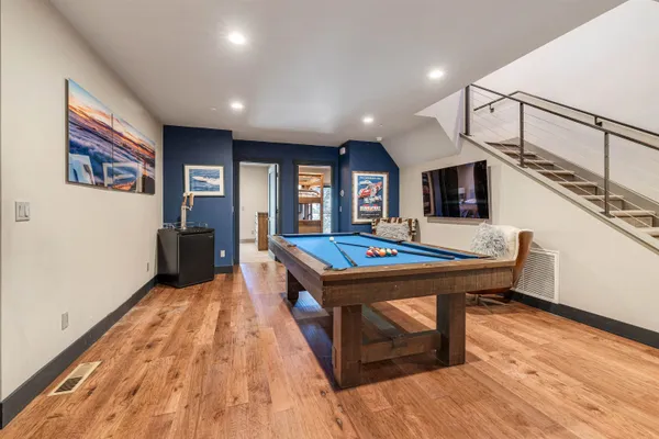 a living room with a table chairs and kitchen view