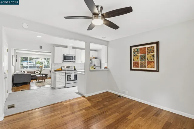 a view of a kitchen with microwave and stove top oven