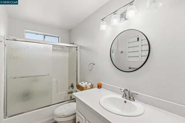a bathroom with a sink toilet and a mirror