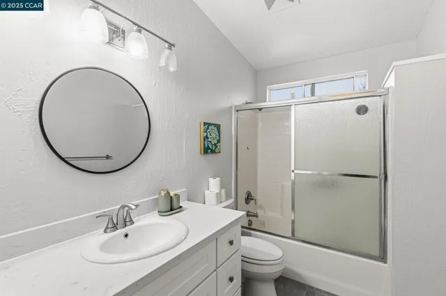 a bathroom with a sink toilet and a mirror
