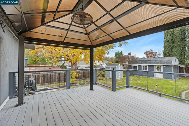 a view of a balcony with wooden floor