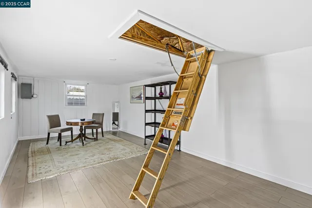 a view of a livingroom with furniture and stairs