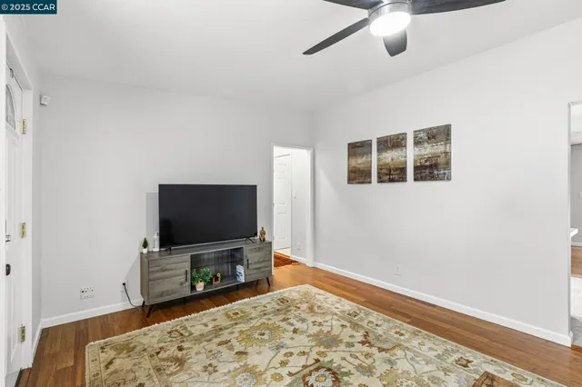 a room with wooden floor and a flat screen tv