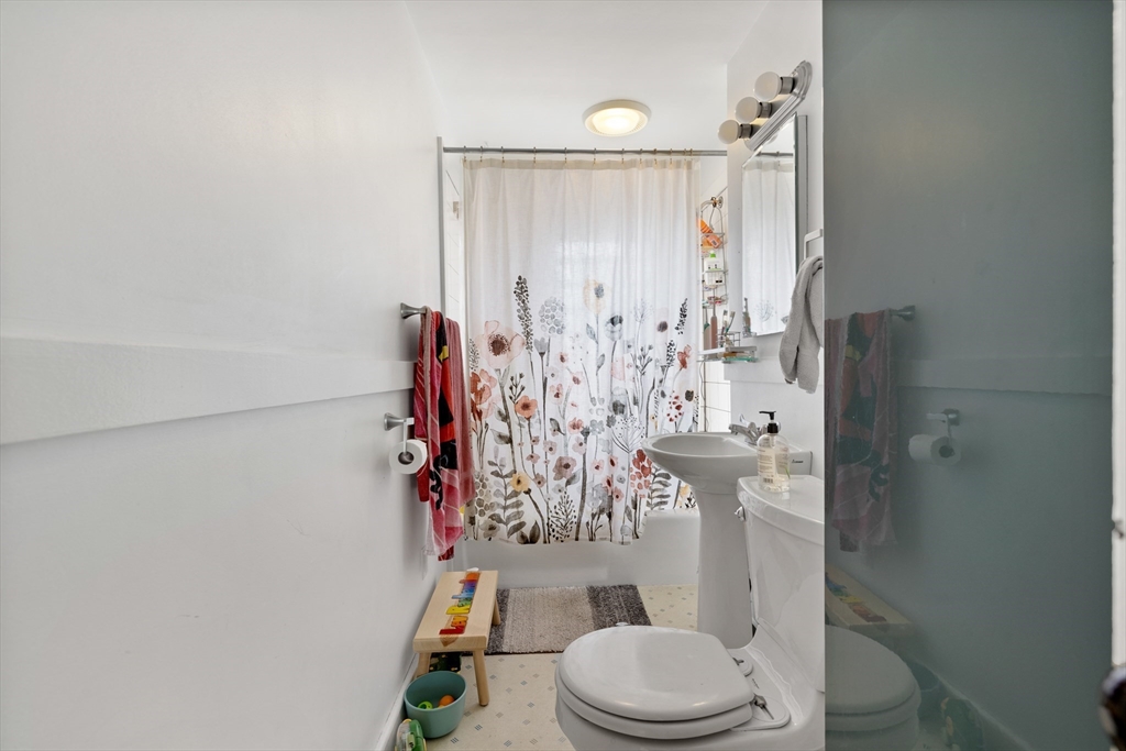 14-16 Holyoke Road Somerville, MA 02144 - Photo 12 of 34 a bathroom with a toilet and shower curtain