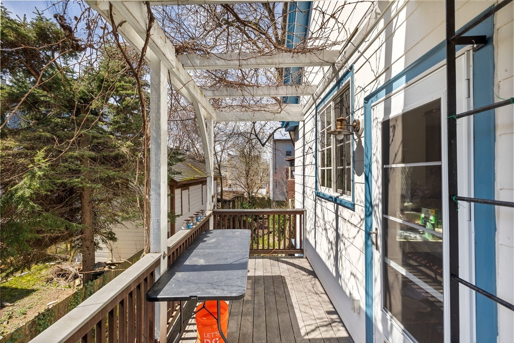14-16 Holyoke Road Somerville, MA 02144 - Photo 17 of 34 a view of a balcony with wooden floor and door