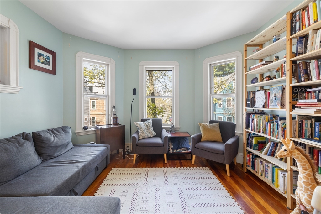 14-16 Holyoke Road Somerville, MA 02144 - Photo 2 of 34 a living room with furniture and a book shelf