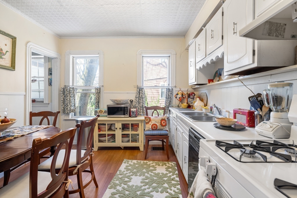 14-16 Holyoke Road Somerville, MA 02144 - Photo 21 of 34 a kitchen with a stove a sink and a refrigerator
