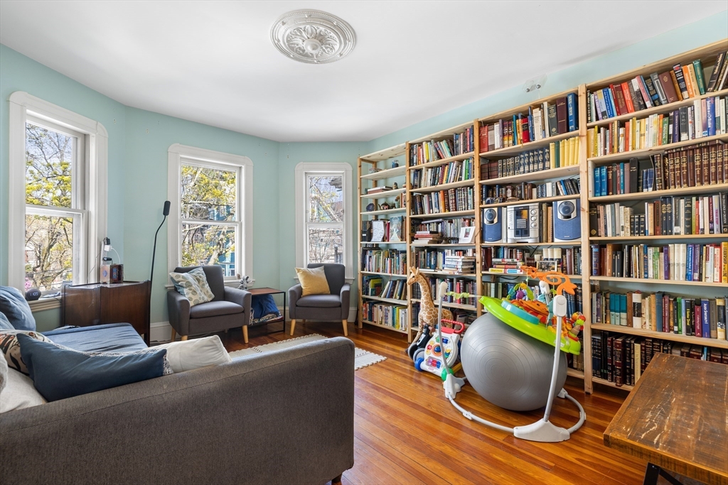 14-16 Holyoke Road Somerville, MA 02144 - Photo 3 of 34 a living room with furniture and a book shelf