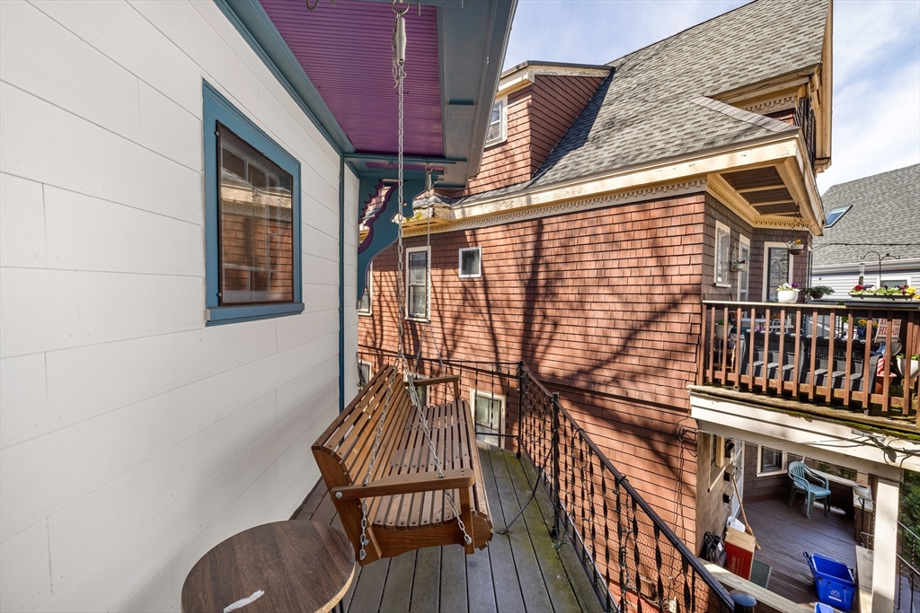 14-16 Holyoke Road Somerville, MA 02144 - Photo 7 of 34 a balcony with table and chairs
