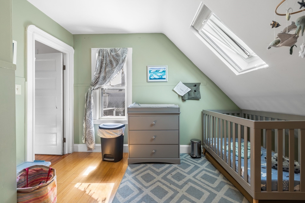 14-16 Holyoke Road Somerville, MA 02144 - Photo 9 of 34 a living room with a baby crib furniture and a window