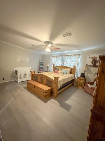 a spacious bedroom with a bed and a window