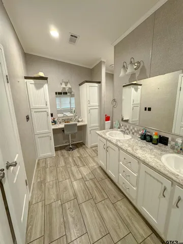 a large white kitchen with a stove a sink dishwasher and a refrigerator