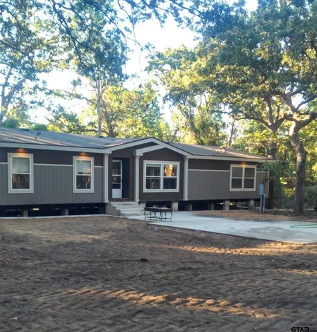 a house that has a tree in front of it
