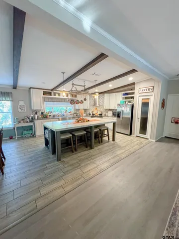 a room with lots of furniture and a kitchen