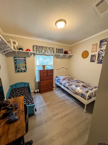 a bedroom with furniture and a window