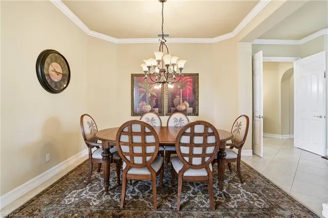 a dining room with furniture and a chandelier