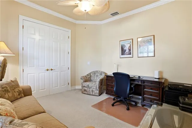 a livingroom with workspace and a couch