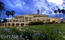 a room with lots of tables a large window and chairs