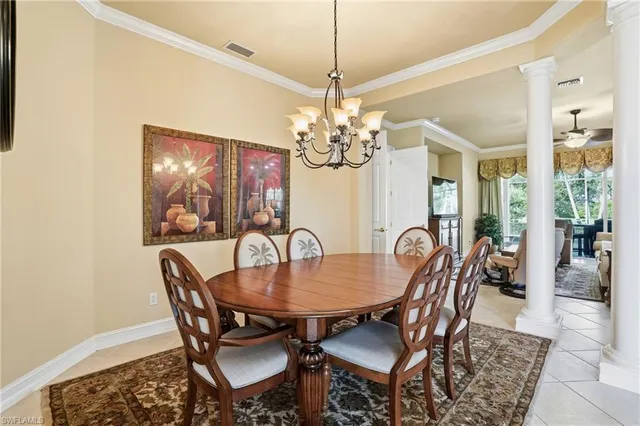 a dining room with furniture a chandelier and wooden floor