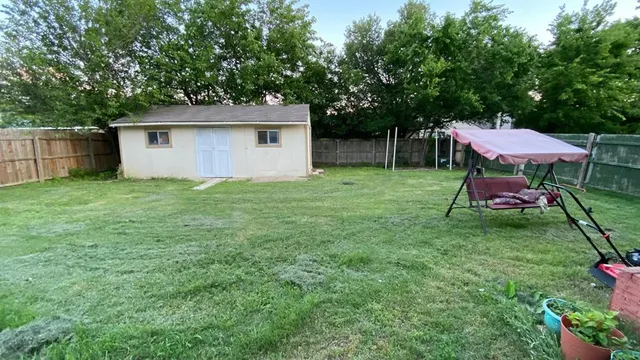 a backyard of a house with table and chairs