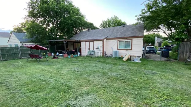 a view of a house with a yard porch and sitting area