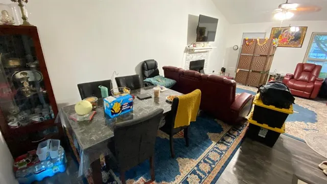 a living room with furniture fireplace and flat screen tv