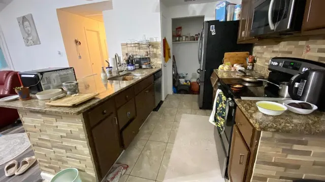 a kitchen with a sink appliances and cabinets